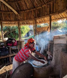 The chef cook of the eco lodge, Silenat, uses the first smokeless stove of the area. This is the model stove for all the farmers houses.